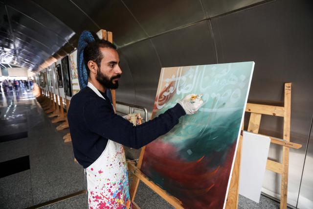 (251222) -- CAIRO, Dec. 22, 2025 (Xinhua) -- A man demonstrates Arabic calligraphy during an event marking World Arabic Language Day at the National Museum of Egyptian Civilization in Cairo, Egypt, Dec. 21, 2025.
  A three-day cultural event marking World Arabic Language Day kicked off on Sunday in Egypt's capital Cairo.
  With the theme of "A Renewed Heritage in a Radiant Script," the event features exhibitions, live music performances with traditional Arabic instruments, seminars, and interactive workshops that highlight the enduring legacy and evolving art of the Arabic alphabet. (Xinhua/Ahmed Gomaa)