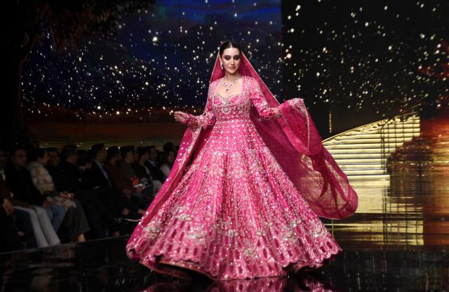 (251222) -- LAHORE, Dec. 22, 2025 (Xinhua) -- A model presents a creation during the Hum Bridal Couture Week fashion show in Lahore, Pakistan on Dec. 21, 2025. (Photo by Sajjad/Xinhua)