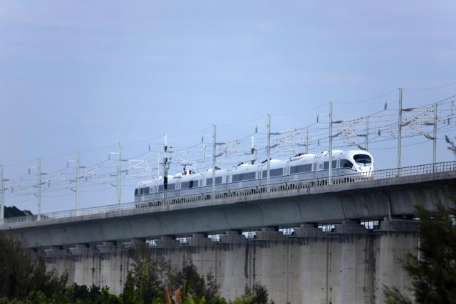 (251222) -- SHANTOU, Dec. 22, 2025 (Xinhua) -- This photo taken on Dec. 22, 2025 shows a high-speed train running on the Haojiang grand bridge in south China's Guangdong Province. The Shantou-Shantou South section of the 162-km-long Shantou-Shanwei high-speed railway was completed and opened to traffic on Monday, marking the full-line operation of the railway. (Photo by Yao Jun/Xinhua)