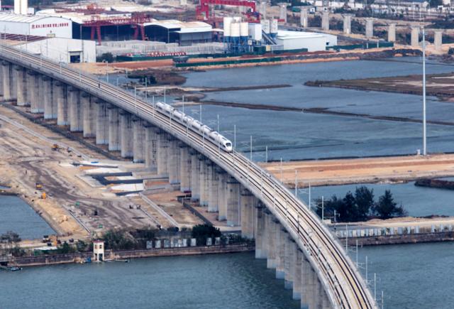 (251222) -- SHANTOU, Dec. 22, 2025 (Xinhua) -- This photo taken on Dec. 22, 2025 shows a high-speed train running on the Haojiang grand bridge in south China's Guangdong Province. The Shantou-Shantou South section of the 162-km-long Shantou-Shanwei high-speed railway was completed and opened to traffic on Monday, marking the full-line operation of the railway. (Photo by Yao Jun/Xinhua)