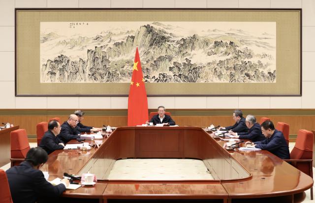 (251222) -- BEIJING, Dec. 22, 2025 (Xinhua) -- Chinese Premier Li Qiang, also a member of the Standing Committee of the Political Bureau of the Communist Party of China (CPC) Central Committee, presides over a State Council leading-group meeting on the formulation of the draft outline of China's 15th Five-Year Plan for Economic and Social Development in Beijing, capital of China, Dec. 22, 2025. Vice Premier Ding Xuexiang, also a member of the Standing Committee of the Political Bureau of the CPC Central Committee, attended the meeting. (Xinhua/Huang Jingwen)