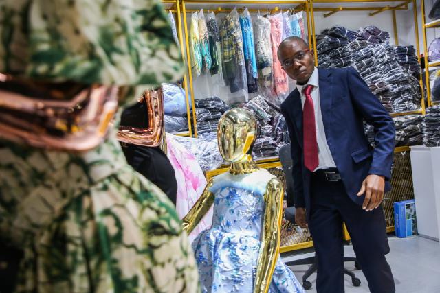 (251222) -- DAR ES SALAAM, Dec. 22, 2025 (Xinhua) -- A trader checks clothing displays inside a wholesale showroom at the East Africa Commercial and Logistics Center (EACLC) in Dar es Salaam, Tanzania, Dec. 19, 2025. TO GO WITH "Feature: Chinese-built logistics hub in Tanzania streamlines regional trade across East Africa" (Xinhua/Emmanuel Herman)