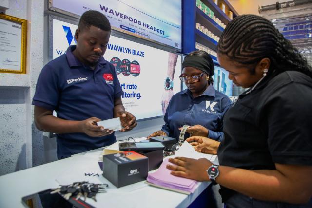 (251222) -- DAR ES SALAAM, Dec. 22, 2025 (Xinhua) -- Staff members assist customers at a shop selling electronic products at the East Africa Commercial and Logistics Center (EACLC) in Dar es Salaam, Tanzania, Dec. 19, 2025. TO GO WITH "Feature: Chinese-built logistics hub in Tanzania streamlines regional trade across East Africa" (Xinhua/Emmanuel Herman)
