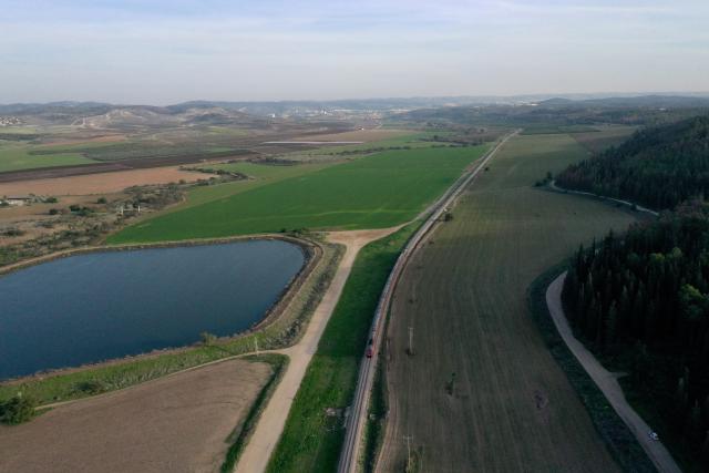 (251223) -- BET SHEMESH, Dec. 23, 2025 (Xinhua) -- A drone photo taken on Dec. 22, 2025 shows a rail track running through farm fields near Bet Shemesh, Israel. Israel has experienced unusually early and heavy rains this winter, with precipitation in many areas already reaching the annual average. The rainfall has eased drought conditions in some parts of the country. (Photo by Gil Cohen Magen/Xinhua)