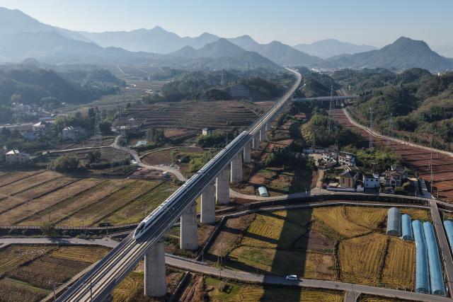(251223) -- YINCHUAN, Dec. 23, 2025 (Xinhua) -- An aerial drone photo shows a bullet train running on a bridge along the Hangzhou-Quzhou high-speed railway in east China's Zhejiang Province, Nov. 20, 2025. (Xinhua/Huang Zongzhi)