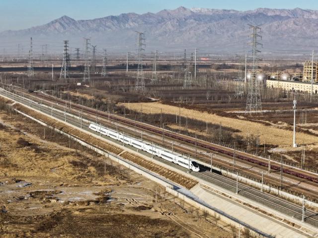 (251223) -- BAOTOU, Dec. 23, 2025 (Xinhua) -- A drone photo taken on Dec. 23, 2025 shows bullet train No.D4667 running on the Baotou-Yinchuan High-Speed Railway. The Baotou-Huinong section of the Baotou-Yinchuan High-Speed Railway was completed and opened to traffic on Tuesday, marking the full-line operation of the railway.
  This railway connects Baotou in north China's Inner Mongolia Autonomous Region with Yinchuan in northwest China's Ningxia Hui Autonomous Region, enhancing the high-speed railway network in northwest China. (Photo by Li Chao/Xinhua)