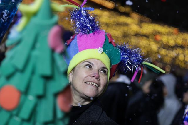 (251223) -- MEXICO CITY, Dec. 23, 2025 (Xinhua) -- A visitor is pictured during a winter lights festival at the Zocalo square in Mexico City, Mexico, Dec. 22, 2025. A winter lights festival is held here to welcome the arrival of 2026. (Xinhua/Francisco Canedo)