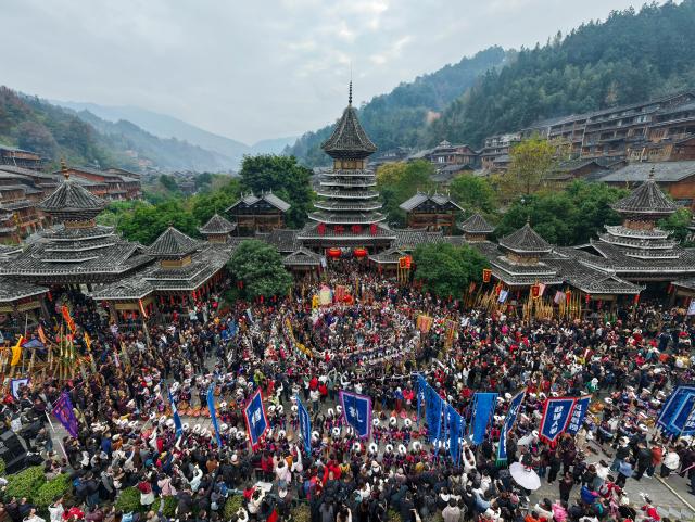 (251223) -- GUIYANG, Dec. 23, 2025 (Xinhua) -- A drone photo taken on Dec. 20, 2025 shows people celebrating the annual Dong New Year festival in Zhaoxing Dong village of Liping County, Qiandongnan Miao and Dong Autonomous Prefecture, southwest China's Guizhou Province. TO GO WITH "Across China: Ethnic New Year celebrations in China draw global visitors" (Photo by Long Jianrui/Xinhua)