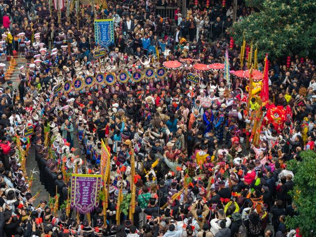 (251223) -- GUIYANG, Dec. 23, 2025 (Xinhua) -- A drone photo taken on Dec. 20, 2025 shows people celebrating the annual Dong New Year festival in Zhaoxing Dong village of Liping County, Qiandongnan Miao and Dong Autonomous Prefecture, southwest China's Guizhou Province. TO GO WITH "Across China: Ethnic New Year celebrations in China draw global visitors" (Photo by Long Jianrui/Xinhua)