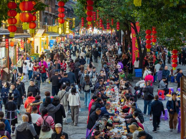 (251223) -- GUIYANG, Dec. 23, 2025 (Xinhua) -- A long-table banquet is held to celebrate the annual Dong New Year festival in Zhaoxing Dong village of Liping County, Qiandongnan Miao and Dong Autonomous Prefecture, southwest China's Guizhou Province, Dec. 20, 2025. TO GO WITH "Across China: Ethnic New Year celebrations in China draw global visitors" (Photo by Long Jianrui/Xinhua)
