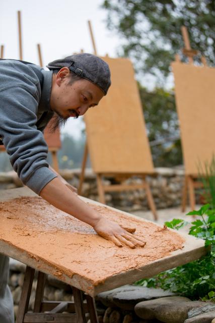 (251223) -- WUYISHAN, Dec. 23, 2025 (Xinhua) -- An artist makes boards for rock pigment paintings in Wuyishan City, southeast China's Fujian Province, Dec. 22, 2025. Wuyishan boasts a wide range of colorful rock and soil, which serve as a natural palette for painting, giving rise to the distinctive Wuyi rock pigment art. Integrating modern artistic elements and techniques into tradition, Wuyi rock pigment painting is gradually becoming a unique cultural feature of Wuyishan. (Photo by Chen Ying/Xinhua)