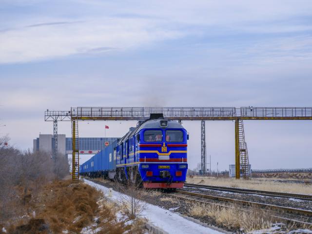 (251223) -- ERENHOT, Dec. 23, 2025 (Xinhua) -- An inbound China-Europe freight train passes through a land port in Erenhot, north China's Inner Mongolia Autonomous Region, Dec. 22, 2025. Erenhot, the largest land port on the China-Mongolia border, is a pivotal point of the China-Mongolia-Russia Economic Corridor. As of Dec. 22, inbound and outbound passenger traffic volumes and the number of vehicles driving through Erenhot reached 2.753 million and 741,000, respectively, up by 8.8 percent and 12.1 percent compared with the same period of last year. (Xinhua/Ma Jinrui)