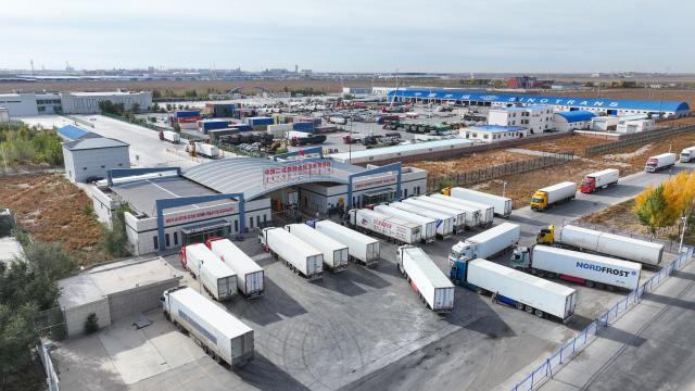(251223) -- ERENHOT, Dec. 23, 2025 (Xinhua) -- An aerial drone photo taken on Oct. 10, 2025 shows a border trade zone in Erenhot, north China's Inner Mongolia Autonomous Region. Erenhot, the largest land port on the China-Mongolia border, is a pivotal point of the China-Mongolia-Russia Economic Corridor. As of Dec. 22, inbound and outbound passenger traffic volumes and the number of vehicles driving through Erenhot reached 2.753 million and 741,000, respectively, up by 8.8 percent and 12.1 percent compared with the same period of last year. (Photo by Guo Pengjie/Xinhua)