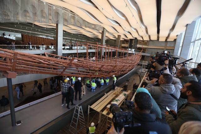 (251223) -- CAIRO, Dec. 23, 2025 (Xinhua) -- The restoration team work on the restoration project for the ancient King Khufu's second solar boat at the Grand Egyptian Museum in Cairo, Egypt, Dec. 23, 2025. Egypt on Tuesday began reassembling ancient King Khufu's second solar boat at the newly opened Grand Egyptian Museum, a restoration process expected to take about four years and open for visitors to watch live. (Xinhua/Ahmed Gomaa)
