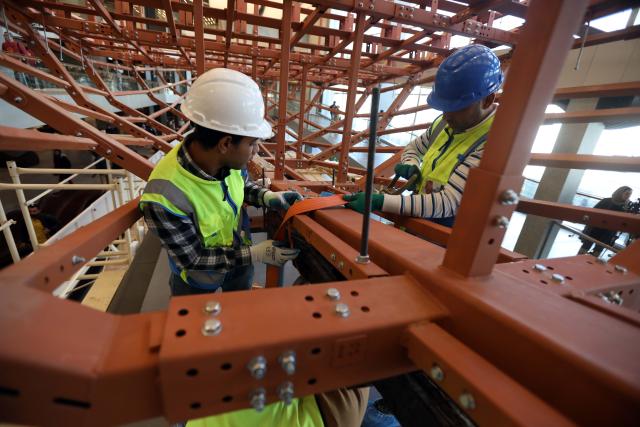 (251223) -- CAIRO, Dec. 23, 2025 (Xinhua) -- The restoration team work on the restoration project for the ancient King Khufu's second solar boat at the Grand Egyptian Museum in Cairo, Egypt, Dec. 23, 2025. Egypt on Tuesday began reassembling ancient King Khufu's second solar boat at the newly opened Grand Egyptian Museum, a restoration process expected to take about four years and open for visitors to watch live. (Xinhua/Ahmed Gomaa)