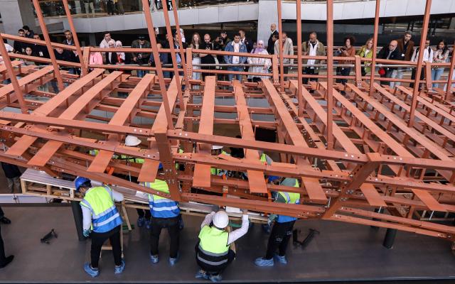 (251223) -- CAIRO, Dec. 23, 2025 (Xinhua) -- The restoration team work on the restoration project for the ancient King Khufu's second solar boat at the Grand Egyptian Museum in Cairo, Egypt, Dec. 23, 2025. Egypt on Tuesday began reassembling ancient King Khufu's second solar boat at the newly opened Grand Egyptian Museum, a restoration process expected to take about four years and open for visitors to watch live. (Xinhua/Ahmed Gomaa)