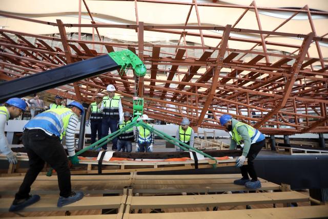 (251223) -- CAIRO, Dec. 23, 2025 (Xinhua) -- The restoration team work on the restoration project for the ancient King Khufu's second solar boat at the Grand Egyptian Museum in Cairo, Egypt, Dec. 23, 2025. Egypt on Tuesday began reassembling ancient King Khufu's second solar boat at the newly opened Grand Egyptian Museum, a restoration process expected to take about four years and open for visitors to watch live. (Xinhua/Ahmed Gomaa)