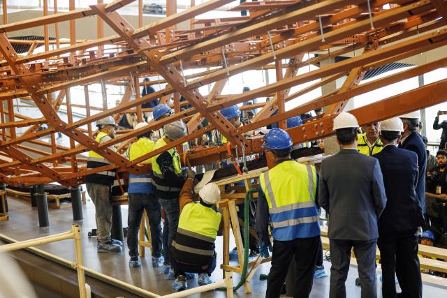 (251223) -- CAIRO, Dec. 23, 2025 (Xinhua) -- The restoration team work on the restoration project for the ancient King Khufu's second solar boat at the Grand Egyptian Museum in Cairo, Egypt, Dec. 23, 2025. Egypt on Tuesday began reassembling ancient King Khufu's second solar boat at the newly opened Grand Egyptian Museum, a restoration process expected to take about four years and open for visitors to watch live. (Xinhua/Ahmed Gomaa)