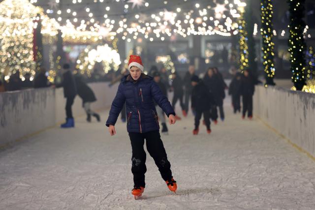(251224) -- BISHKEK, Dec. 24, 2025 (Xinhua) -- People skate at the Ala-Too Square during a New Year event in Bishkek, Kyrgyzstan, Dec. 23, 2025. (Photo by Roman/Xinhua)