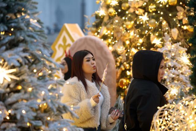 (251224) -- BISHKEK, Dec. 24, 2025 (Xinhua) -- People visit the Ala-Too Square during a New Year event in Bishkek, Kyrgyzstan, Dec. 23, 2025. (Photo by Roman/Xinhua)