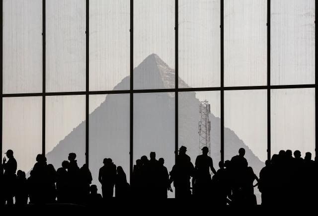(251224) -- BEIJING, Dec. 24, 2025 (Xinhua) -- This photo shows a distant view of the Egyptian pyramid as seen from inside the Grand Egyptian Museum in the Greater Cairo, Egypt, Dec. 23, 2025. (Xinhua/Ahmed Gomaa)