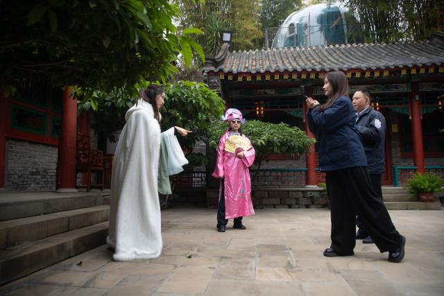 (251224) -- CHONGQING, Dec. 24, 2025 (Xinhua) -- Tang Hexia (2nd L) and Wen Yu (1st L) film a short video in southwest China's Chongqing Municipality, Dec. 10, 2025. China's total cross-border e-commerce import and export value reached 1.37 trillion yuan in the first half of 2025, a year-on-year increase of 10.3 percent. The rapid growth of the cross-border e-commerce industry has led to a surge in job demand. The "cross-border e-commerce operations manager" has been added to the 17 new professions unveiled by the Ministry of Human Resources and Social Security in 2025.
   Tang Hexia, 29, an employee of Mexin Group, a door and window manufacturer based in Chongqing, became a cross-border e-commerce operations manager in 2025. She joined the cross-border e-commerce department of the company with colleagues Deng Yong and Wen Yu.
   Their main duties include selling products in foreign languages via overseas e-commerce platforms, responding to customer inquiries, and offering customization and after-sales services. They also perform market analysis to optimize e-commerce platform pages of the company and adjust their service models according to foreign customers' preferences.
   Creating short videos is also part of Tang's job. She and colleagues post videos on overseas social media platforms to introduce products and to expand the brand's influence.
  Cross-border e-commerce involves not only communicating with foreign customers in their languages, but also understanding their lifestyles and ways of thinking, Tang stated. Cross-border e-commerce operations managers must be knowledgeable about product features, accurately relay clients' requirements to the production department, and grasp the preferences and demands of overseas consumers.
   Tang has strong confidence in the prospect of this profession and hopes to boost the global recognition of Chinese brands through innovative efforts in the future. (Xinhua/Tang Yi)