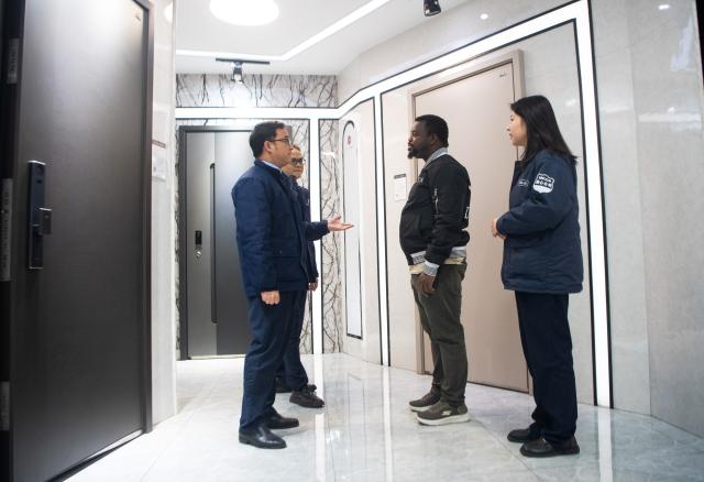 (251224) -- CHONGQING, Dec. 24, 2025 (Xinhua) -- Tang Hexia (1st R) and Deng Yong (1st L) introduce products to a foreign client in southwest China's Chongqing Municipality, Dec. 15, 2025. China's total cross-border e-commerce import and export value reached 1.37 trillion yuan in the first half of 2025, a year-on-year increase of 10.3 percent. The rapid growth of the cross-border e-commerce industry has led to a surge in job demand. The "cross-border e-commerce operations manager" has been added to the 17 new professions unveiled by the Ministry of Human Resources and Social Security in 2025.
   Tang Hexia, 29, an employee of Mexin Group, a door and window manufacturer based in Chongqing, became a cross-border e-commerce operations manager in 2025. She joined the cross-border e-commerce department of the company with colleagues Deng Yong and Wen Yu.
   Their main duties include selling products in foreign languages via overseas e-commerce platforms, responding to customer inquiries, and offering customization and after-sales services. They also perform market analysis to optimize e-commerce platform pages of the company and adjust their service models according to foreign customers' preferences.
   Creating short videos is also part of Tang's job. She and colleagues post videos on overseas social media platforms to introduce products and to expand the brand's influence.
  Cross-border e-commerce involves not only communicating with foreign customers in their languages, but also understanding their lifestyles and ways of thinking, Tang stated. Cross-border e-commerce operations managers must be knowledgeable about product features, accurately relay clients' requirements to the production department, and grasp the preferences and demands of overseas consumers.
   Tang has strong confidence in the prospect of this profession and hopes to boost the global recognition of Chinese brands through innovative efforts in the future. (Xinhua/Tang Yi)