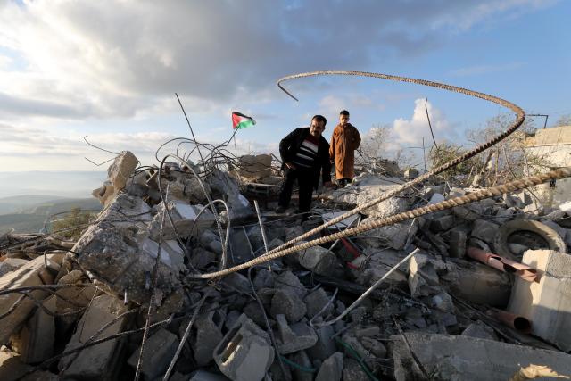 (251225) -- BEIJING, Dec. 25, 2025 (Xinhua) -- Palestinians inspect the damage after a house was bulldozed by an Israeli bulldozer in the town of Bizzariya, northwest of Nablus in the West Bank, on Dec. 24, 2025. (Photo by Nidal Eshtayeh/Xinhua)