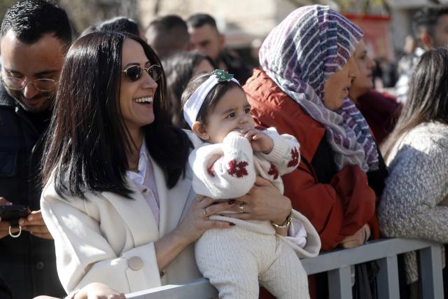 (251225) -- BETHLEHEM, Dec. 25, 2025 (Xinhua) -- Visitors are seen during the performances held at the Manger Square in Bethlehem, southern West Bank, on Dec. 24, 2025. Bethlehem is embracing the events marking the Christmas season. (Photo by Mamoun Wazwaz/Xinhua)