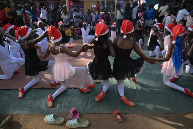 (251225) -- NAIROBI, Dec. 25, 2025 (Xinhua) -- Young dancers perform on a simple stage at the Kibera slum in Nairobi, Kenya, Dec. 23, 2025. A Christmas ballet performance organized by the Kibera Ballet School was held here on Tuesday, attracting many local residents to watch. (Xinhua/Yang Guang)