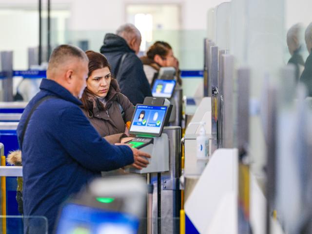 (251225) -- MANZHOULI, Dec. 25, 2025 (Xinhua) -- People go through entry formalities at the Manzhouli land port in Manzhouli City, north China's Inner Mongolia Autonomous Region, Dec. 24, 2025. Manzhouli City, a historic port city on the China-Russia border, has been unleashing its vigor in city development with continuously deepening of opening-up. According to data released by the Manzhouli station of exit and entry frontier inspection, the Manzhouli port has handled over 900,000 inbound and outbound passenger trips this year as of Dec. 23. (Xinhua/Ma Jinrui)