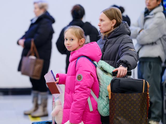 (251225) -- MANZHOULI, Dec. 25, 2025 (Xinhua) -- Inbound passengers queue to receive identity check at the Manzhouli land port in Manzhouli City, north China's Inner Mongolia Autonomous Region, Dec. 24, 2025. Manzhouli City, a historic port city on the China-Russia border, has been unleashing its vigor in city development with continuously deepening of opening-up. According to data released by the Manzhouli station of exit and entry frontier inspection, the Manzhouli port has handled over 900,000 inbound and outbound passenger trips this year as of Dec. 23. (Xinhua/Ma Jinrui)