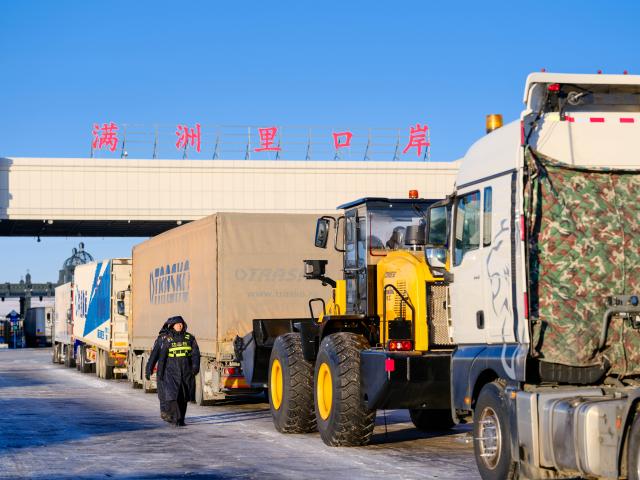(251225) -- MANZHOULI, Dec. 25, 2025 (Xinhua) -- Outbound cargo trucks queue to go through the Manzhouli land port in Manzhouli City, north China's Inner Mongolia Autonomous Region, Dec. 23, 2025. Manzhouli City, a historic port city on the China-Russia border, has been unleashing its vigor in city development with continuously deepening of opening-up. According to data released by the Manzhouli station of exit and entry frontier inspection, the Manzhouli port has handled over 900,000 inbound and outbound passenger trips this year as of Dec. 23. (Xinhua/Ma Jinrui)