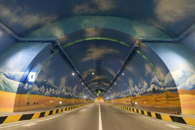 (251225) -- URUMQI, Dec. 25, 2025 (Xinhua) -- This photo taken on Dec. 21, 2025 shows a view of the Tianshan Shengli Tunnel on Urumqi-Yuli Expressway in northwest China's Xinjiang Uygur Autonomous Region. The Tianshan Shengli Tunnel, the world's longest expressway tunnel, and the Urumqi-Yuli Expressway that traverses the Tianshan Mountains via the tunnel, will be open to traffic by the end of this year, enabling a new shortcut linking southern and northern parts of Xinjiang.
  The 22.13-kilometer tunnel will reduce the time it takes to drive across the middle section of the Tianshan Mountains from several hours to about 20 minutes.
   Once operational, the travel time from the regional capital of Urumqi, north of the Tianshan Mountains, to Korla, south of the Tianshan Mountains, will be shortened from seven hours to about three hours. (Xinhua/Hu Huhu)