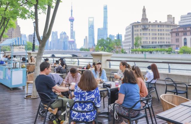 (251225) -- SHANGHAI, Dec. 25, 2025 (Xinhua) -- This photo taken on May 13, 2025 shows Clarisse Le Guernic, a French woman working as a local tour guide, leading foreign tourists in a "citywalk" tour in Shanghai, east China. As China's latest chapter of inbound tourism begins to take shape, there are a loosely connected group of people who do not fit neatly into media narratives or influencer culture. They are present in everyday encounters, helping visitors bridge the gap between assumption and experience. In China's media and academic cultural communication circles, people have begun calling them "cultural ferrymen."
     Some are Chinese professionals who have turned away from conventional tourism; others are foreigners who have built their lives in China and now find themselves translating it. Together, they are reshaping how international visitors experience the country -- not as a spectacle, but as a lived reality. (Xinhua)
