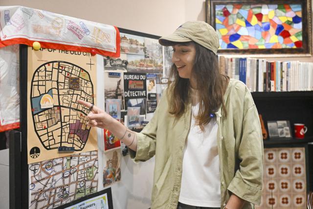(251225) -- SHANGHAI, Dec. 25, 2025 (Xinhua) -- This photo taken on Sept. 22, 2025 shows Clarisse Le Guernic, a French woman working as a local tour guide, introducing the "citywalk" routes she explored at a studio in Shanghai, east China. As China's latest chapter of inbound tourism begins to take shape, there are a loosely connected group of people who do not fit neatly into media narratives or influencer culture. They are present in everyday encounters, helping visitors bridge the gap between assumption and experience. In China's media and academic cultural communication circles, people have begun calling them "cultural ferrymen."
     Some are Chinese professionals who have turned away from conventional tourism; others are foreigners who have built their lives in China and now find themselves translating it. Together, they are reshaping how international visitors experience the country -- not as a spectacle, but as a lived reality. (Xinhua/Chen Haoming)