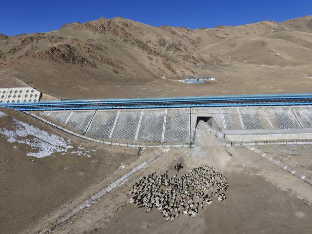 (251225) -- URUMQI, Dec. 25, 2025 (Xinhua) -- An aerial drone photo taken on Dec. 23, 2025 shows a herdsman driving sheep on the side of Urumqi-Yuli Expressway in Hejing County, northwest China's Xinjiang Uygur Autonomous Region. The Tianshan Shengli Tunnel, the world's longest expressway tunnel, and the Urumqi-Yuli Expressway that traverses the Tianshan Mountains via the tunnel, will be open to traffic by the end of this year, enabling a new shortcut linking southern and northern parts of Xinjiang.
  The 22.13-kilometer tunnel will reduce the time it takes to drive across the middle section of the Tianshan Mountains from several hours to about 20 minutes.
   Once operational, the travel time from the regional capital of Urumqi, north of the Tianshan Mountains, to Korla, south of the Tianshan Mountains, will be shortened from seven hours to about three hours. (Xinhua/Hu Huhu)