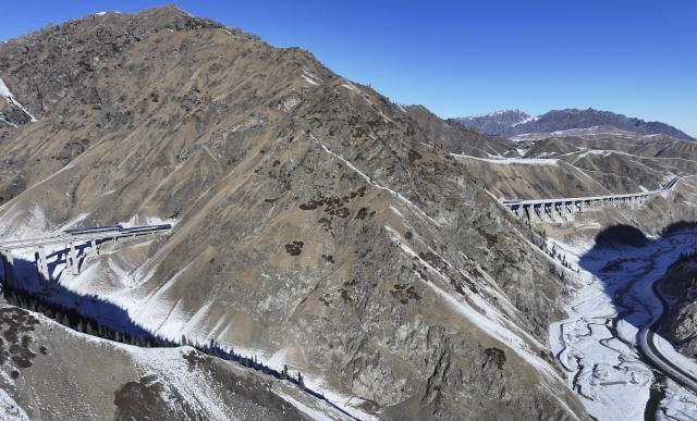 (251225) -- URUMQI, Dec. 25, 2025 (Xinhua) -- An aerial panorama photo taken on Dec. 23, 2025 shows a view of Urumqi-Yuli Expressway that traverses the Tianshan Mountains in northwest China's Xinjiang Uygur Autonomous Region. The Tianshan Shengli Tunnel, the world's longest expressway tunnel, and the Urumqi-Yuli Expressway that traverses the Tianshan Mountains via the tunnel, will be open to traffic by the end of this year, enabling a new shortcut linking southern and northern parts of Xinjiang.
  The 22.13-kilometer tunnel will reduce the time it takes to drive across the middle section of the Tianshan Mountains from several hours to about 20 minutes.
   Once operational, the travel time from the regional capital of Urumqi, north of the Tianshan Mountains, to Korla, south of the Tianshan Mountains, will be shortened from seven hours to about three hours. (Xinhua/Wang Fei)