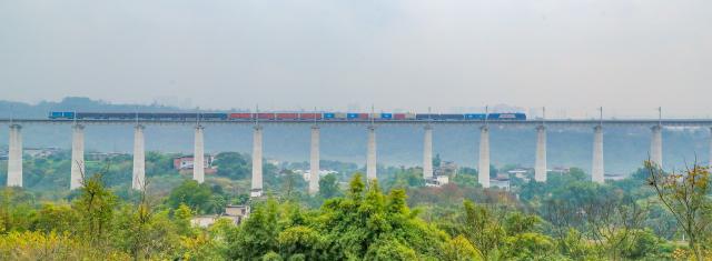 (251225) -- LUZHOU, Dec. 25, 2025 (Xinhua) -- This photo taken on Dec. 25, 2025 shows a freight train running on the Longchang-Luxian-Xuyong railway in Luzhou, southwest China's Sichuan Province. The Longchang-Luxian-Xuyong railway began operation on Thursday as part of China's New International Land-Sea Trade Corridor rail service, which is a crucial logistics link between China's western inland regions and global markets. (Photo by Mu Ke/Xinhua)