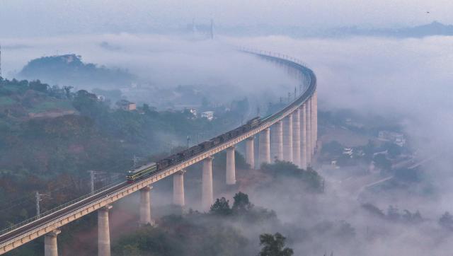 (251225) -- LUZHOU, Dec. 25, 2025 (Xinhua) -- An aerial drone photo taken on Dec. 8, 2025 shows a test train running on the Longchang-Luxian-Xuyong railway in Luzhou, southwest China's Sichuan Province. The Longchang-Luxian-Xuyong railway began operation on Thursday as part of China's New International Land-Sea Trade Corridor rail service, which is a crucial logistics link between China's western inland regions and global markets. (Photo by Liu Xueyi/Xinhua)