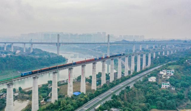 (251225) -- LUZHOU, Dec. 25, 2025 (Xinhua) -- An aerial drone photo taken on Dec. 25, 2025 shows a freight train running on the Longchang-Luxian-Xuyong railway in Luzhou, southwest China's Sichuan Province. The Longchang-Luxian-Xuyong railway began operation on Thursday as part of China's New International Land-Sea Trade Corridor rail service, which is a crucial logistics link between China's western inland regions and global markets. (Photo by Mu Ke/Xinhua)