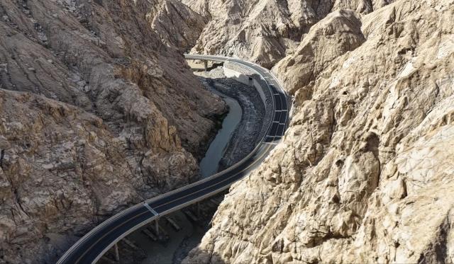 (251225) -- RUOQIANG, Dec. 25, 2025 (Xinhua) -- An aerial drone photo taken on Dec. 25, 2025 shows a resource road in Ruoqiang County, Bayingolin Mongolian Autonomous Prefecture, northwest China's Xinjiang Uygur Autonomous Region. With a total length of 98.45 kilometers, the resource road officially opened to traffic on Thursday. The road starts from an industrial park in Ruoqiang County and passes through the Altun Mountains, connecting the mineral-rich areas in southern Ruoqiang County. (Photo by Su Bo/Xinhua)