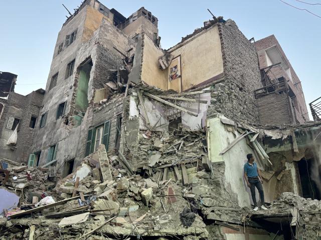 (251225) -- CAIRO, Dec. 25, 2025 (Xinhua) -- A rescuer works on the debris of a collapsed building in Giza, Egypt, Dec. 25, 2025. The death toll from the collapse of a five-story residential building in Egypt's Giza Province, south of Cairo, has risen to eight, Egypt's state-run Ahram Online news website reported on Thursday. (Xinhua/Ahmed Gomaa)