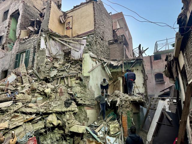 (251225) -- CAIRO, Dec. 25, 2025 (Xinhua) -- Rescuers work on the debris of a collapsed building in Giza, Egypt, Dec. 25, 2025. The death toll from the collapse of a five-story residential building in Egypt's Giza Province, south of Cairo, has risen to eight, Egypt's state-run Ahram Online news website reported on Thursday. (Xinhua/Ahmed Gomaa)