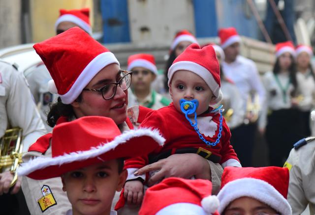 (251225) -- DAMASCUS, Dec. 25, 2025 (Xinhua) -- Photo taken on Dec. 25, 2025, shows a Syrian kid dressed in Santa Claus outfits during a Christmas celebration in Damascus, Syria. (Photo by Ammar Safarjalani/Xinhua)