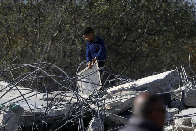 (251225) -- BETHLEHEM, Dec. 25, 2025 (Xinhua) -- A Palestinian child inspects a house demolished by Israeli forces in the village of Al-Khader, south of Bethlehem in the West Bank, Dec. 25, 2025. (Photo by Mamoun Wazwaz/Xinhua)
