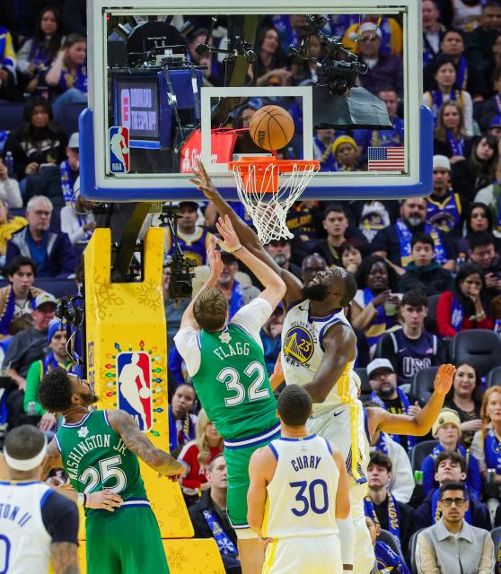 (251226) -- SAN FRANCISCO, Dec. 26, 2025 (Xinhua) -- Draymond Green (top R) of Golden State Warriors defends Cooper Flagg (top L) of Dallas Mavericks during the 2025-2026 NBA regular season game between Golden State Warriors and Dallas Mavericks in San Francisco, the United States, Dec. 25, 2025. (Photo by Arthur Dong/Xinhua)