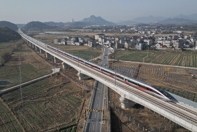 (251226) -- QUZHOU, Dec. 26, 2025 (Xinhua) -- An aerial drone photo taken on Dec. 26, 2025 shows the C3132 passenger train bound for Hangzhou running along the Hangzhou-Quzhou high-speed railway in east China's Zhejiang Province. The 131-km high-speed railway connecting the cities of Hangzhou and Quzhou in Zhejiang puts into operation on Friday. (Xinhua/Huang Zongzhi)