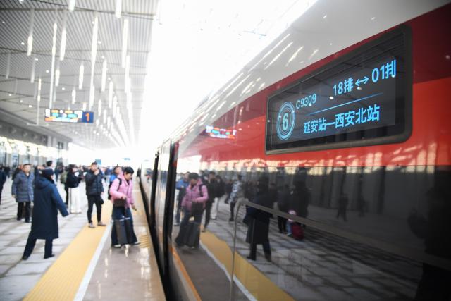 (251226) -- XI'AN, Dec. 26, 2025 (Xinhua) -- Passengers board the first train of the Xi'an-Yan'an high-speed railway at Yan'an Station in Yan'an, northwest China's Shaanxi Province, Dec. 26, 2025. A sleek silver bullet train departed Yan'an in northwest China's Shaanxi Province on Friday, linking the sacred revolutionary heartland to the country's rapidly expanding high-speed rail network.
   The newly opened 299-km line connects Yan'an with Xi'an, the provincial capital and home to the famed Terracotta Warriors, slashing travel time between the two cities from about 2.5 hours to roughly one hour.
   Designed for operations of up to 350 km per hour, the line marked the fastest train running on the Loess Plateau. (Xinhua/Zhang Bowen)