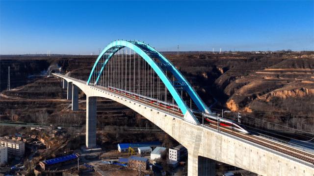 (251226) -- XI'AN, Dec. 26, 2025 (Xinhua) -- An aerial drone photo taken on Dec. 26, 2025 shows a bullet train running on the Wangjiahe grand bridge along Xi'an-Yan'an high-speed railway in northwest China's Shaanxi Province. A sleek silver bullet train departed Yan'an in northwest China's Shaanxi Province on Friday, linking the sacred revolutionary heartland to the country's rapidly expanding high-speed rail network.
   The newly opened 299-km line connects Yan'an with Xi'an, the provincial capital and home to the famed Terracotta Warriors, slashing travel time between the two cities from about 2.5 hours to roughly one hour.
   Designed for operations of up to 350 km per hour, the line marked the fastest train running on the Loess Plateau. (Photo by Ren Wei/Xinhua)